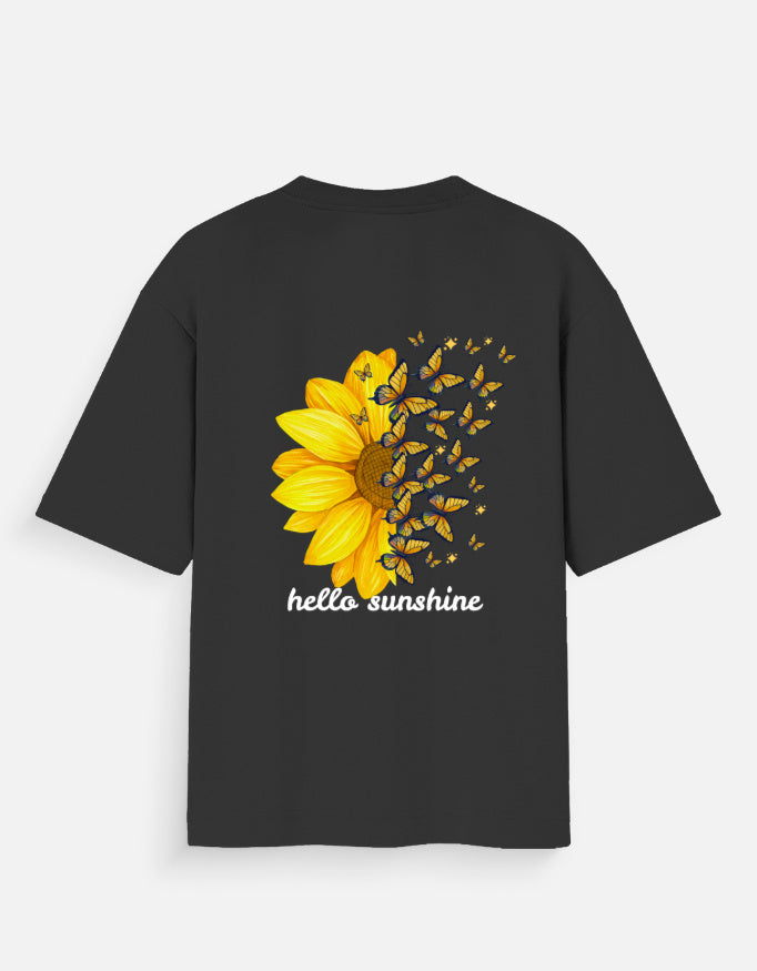 Close-up of a premium cotton oversized tee showing the detailed yellow sunflower print and drop-shoulder stitching.
