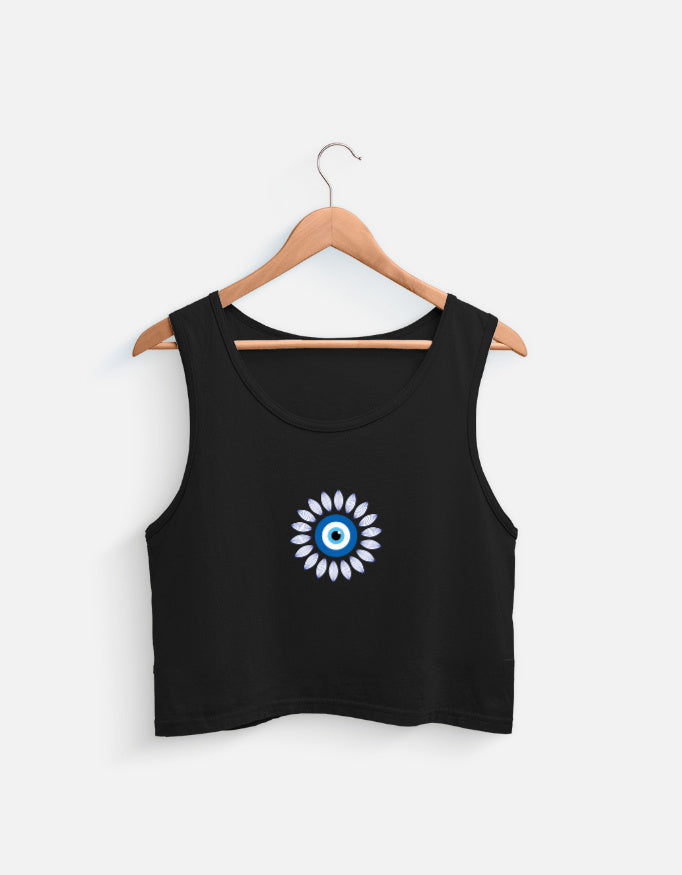 black cotton crop top with blue evil eye graphic on a wooden hanger