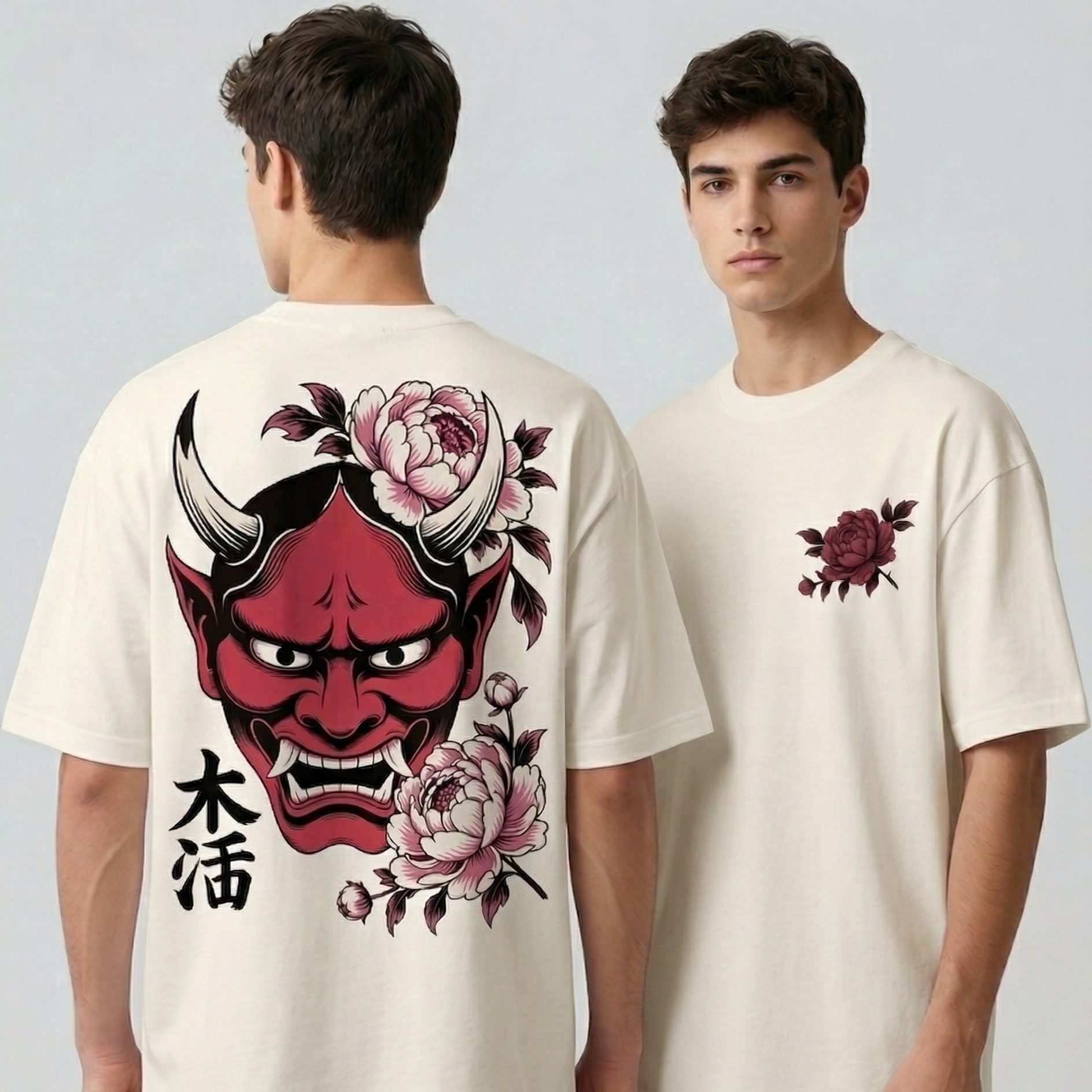 A front and back view of a person modeling an off-white, oversized t-shirt. The back features a large, detailed illustration of a traditional red Japanese Hannya mask surrounded by pink peony flowers and black Kanji characters. The front features a smaller version of the pink flower and leaf design on the upper left chest.
