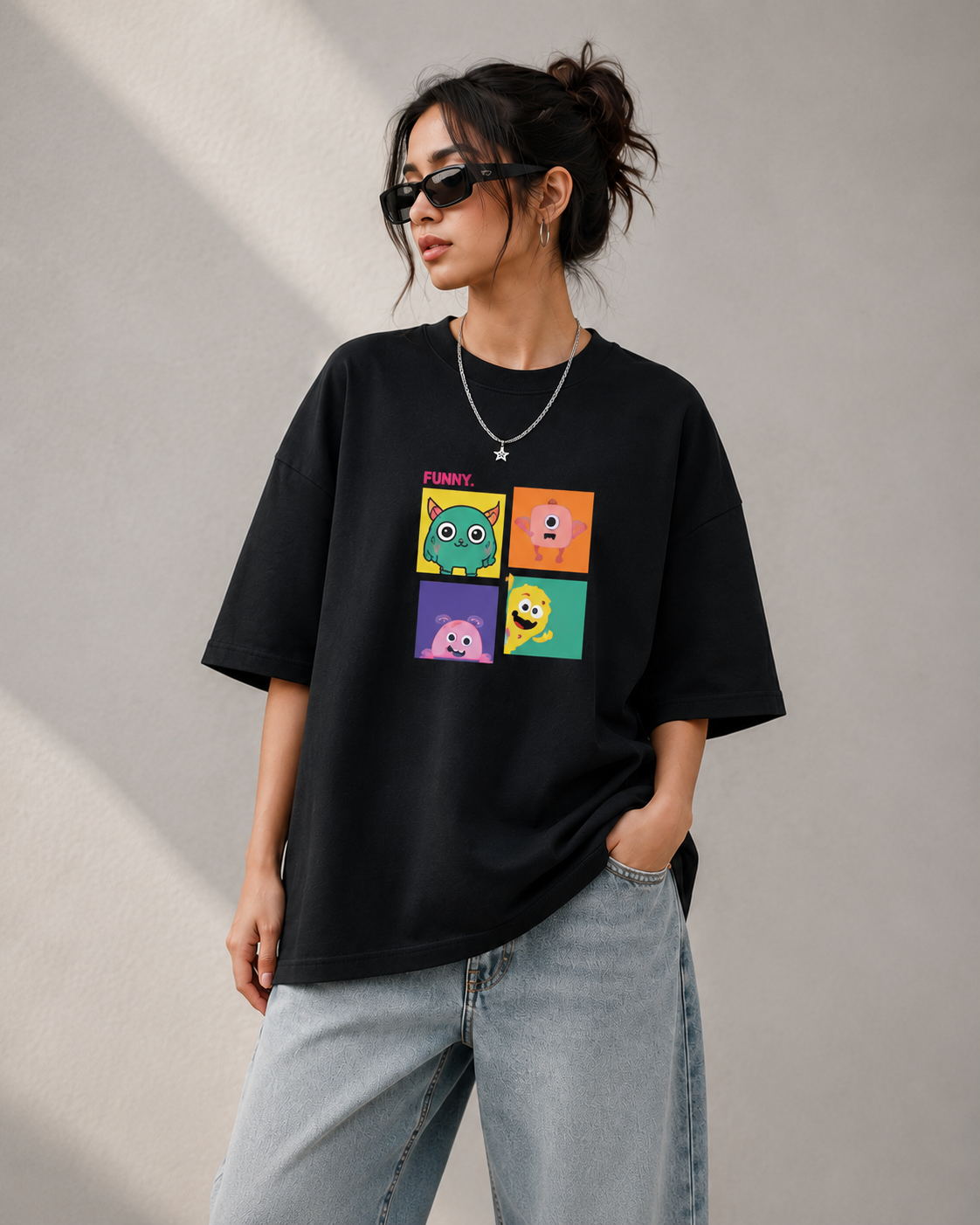 Woman wearing a black oversized graphic t-shirt with colorful cartoon print and relaxed streetwear fit
