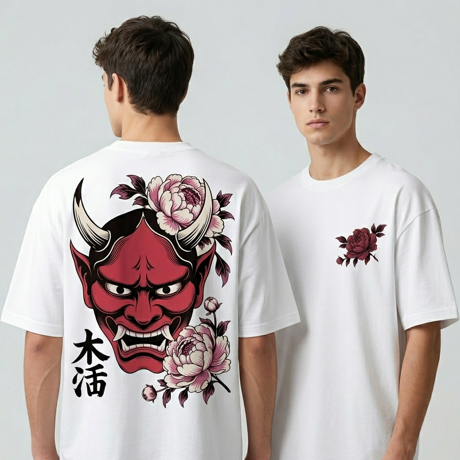 A front and back view of a person modeling an off-white, oversized t-shirt. The back features a large, detailed illustration of a traditional red Japanese Hannya mask surrounded by pink peony flowers and black Kanji characters. The front features a smaller version of the pink flower and leaf design on the upper left chest.