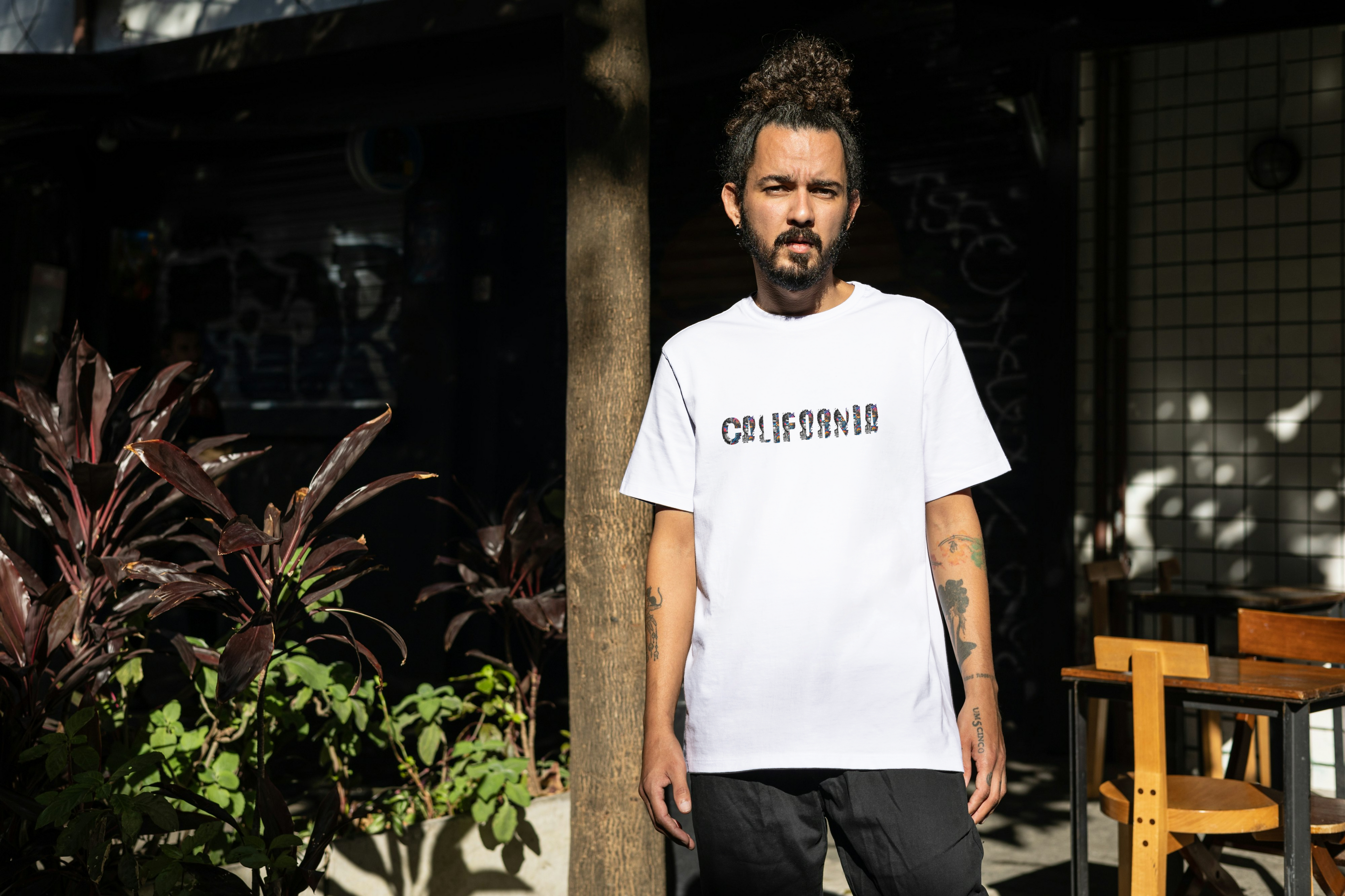Model wearing Street Gully Dual Reality heavyweight oversized white graphic t-shirt with bold print on front.