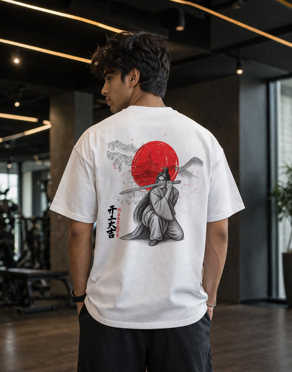 "Back view of a man in a white oversized t-shirt with a red sun and samurai warrior graphic print."